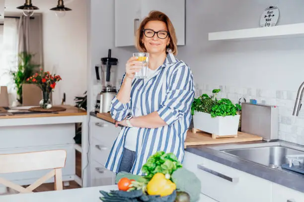 A Person Starting The Day With A Glass Of Water, Addressing Magnesium Deficiency Naturally.